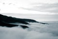 A beautiful monochromatic mountain view with rising clouds Royalty Free Stock Photo