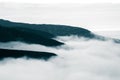 A beautiful monochromatic mountain view with rising clouds Royalty Free Stock Photo