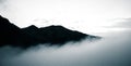 A beautiful monochromatic mountain view with rising clouds Royalty Free Stock Photo