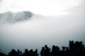 A beautiful monochromatic mountain view with rising clouds