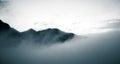 A beautiful monochromatic mountain view with rising clouds Royalty Free Stock Photo