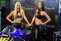 Beautiful Monster Energy girls pose with the motorcycle at Belgrade Car and Motor Show Royalty Free Stock Photo