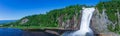 Beautiful Montmorency Falls with rainbow and blue sky. View of Canadian fall located near Quebec City, Canada in North America Royalty Free Stock Photo