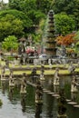 Beautiful monument on indonesian culture and history - Tirta Gangga park with lush green tropical trees, pond, fountain, foothpath