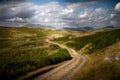 Beautiful moody and cloudy view of the road leading to Devoke Water in the Lake District in Cumbria, England Royalty Free Stock Photo