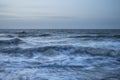 Beautiful dramatic stormy landscape image of waves crashing onto Royalty Free Stock Photo