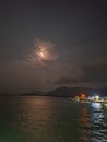 Beautiful moon behind the clouds in the night sky over the sea Royalty Free Stock Photo