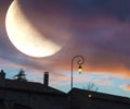 Beautiful moon eclipse over medieval town Royalty Free Stock Photo