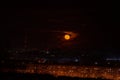 Beautiful moonrise on the background of factory pipes and the city of Novokuznetsk in Russia