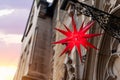 Beautiful Moravian star or Herrnhuter Stern street glowing decoration hanged on wall german city street at christmas Royalty Free Stock Photo