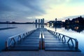 Beautiful morning during blue hour at Putrajaya Lakeside, Malaysia. hotel and building reflection on the lake. wooden and modern j