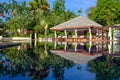 Phuket, Thailand - 05.04.2018: Beautiful view on luxury swimming pool. Chairs, umbrella and palm trees reflected in water. Royalty Free Stock Photo