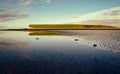 Beautiful morning coastal landscape scenery with mountain reflected in water of sandy Silverstrand beach in Galway, Ireland