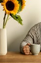 Beautiful morning with coffee and sunflowers on the wooden table