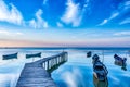 Beautiful morning landscape with boats on the lake anchored to the pier and wood bridges at sunrise Royalty Free Stock Photo