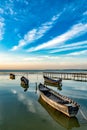 Beautiful morning landscape with boats on the lake anchored to the pier and wood bridges at sunrise Royalty Free Stock Photo