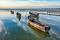 Beautiful morning landscape with boats on the lake anchored to the pier and wood bridges at sunrise Royalty Free Stock Photo