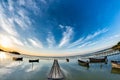 Beautiful morning landscape with boats on the lake anchored to the pier and wood bridges at sunrise