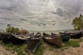 Beautiful morning landscape with a cloudy sky and fishing boats at the Razelm Lake shore