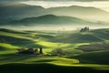 Beautiful morning landscape of green fields on the hills and a village surrounded by fog Royalty Free Stock Photo