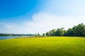 Green grass field with lake in public park Royalty Free Stock Photo