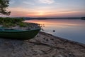 Beautiful morning on the like with green boat on foreground