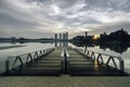 Beautiful morning near the lakeside, modern building and wooden jetty Royalty Free Stock Photo