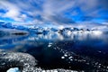 Snowcapped mountains in beautiful landscape, reflecting in blue water, ice flows, Lemaire Channel near Paradise Bay, Antarctica Royalty Free Stock Photo