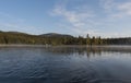 Beautiful morning over lake Sjabatjakjaure with view on Parte Fjallstuga STF mountain cabin, green hills and birch trees