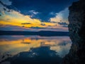 Beautiful morning with rising sun on lake. Mirror clouds