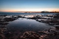 Beautiful morning on the sandy beach. Long exposure at the sea. Milky sunrise in haze and fog. Corralejo, Canary Islands, Spain