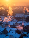 Beautiful morning with sun rising over the Prague roofs covered with fresh snow. Royalty Free Stock Photo