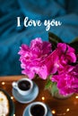 Beautiful morning Vanilla cheesecake, coffee, blue cups, pink peonies in a glass vase. Inscription I love you