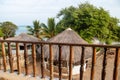 Beautiful morning view on the Indian ocean and the beach from balcony over the hut-tops