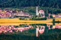 Beautiful morning view of Parrocchia di San Lucano Vescovo Catholic Church. Calm summer scene of Santa Caterina lake and Auronzo d Royalty Free Stock Photo