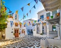 Beautiful morning view of small square decorated for some celebrations with flags in typical Greek town. Greek Orthodox Royalty Free Stock Photo
