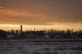 Beautiful morning and winter bright sunrise in January. Suburb and field covered snow Royalty Free Stock Photo