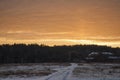 Beautiful morning and winter bright sunrise in January. Suburb and field covered snow