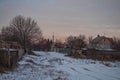 Beautiful morning and winter bright sunrise in January. Suburb and field covered snow