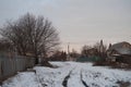 Beautiful morning and winter bright sunrise in January. Suburb and field covered snow