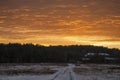 Beautiful morning and winter bright sunrise in January. Suburb and field covered snow Royalty Free Stock Photo