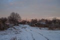 Beautiful morning and winter bright sunrise in January. Suburb and field covered snow Royalty Free Stock Photo