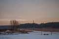 Beautiful morning and winter bright sunrise in January. Suburb and field covered snow Royalty Free Stock Photo