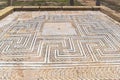 Beautiful mosaic floor with a geometric ornament in the ruins of one of the houses of the ancient Roman city of Italica
