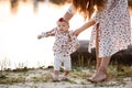 Beautiful mother with baby daughter are having fun and playing near the lake. The concept of summer holiday. Mother`s, baby`s da Royalty Free Stock Photo