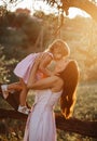 Beautiful Mother And Baby outdoors. Nature. Beauty Mum and her Child playing in Park together. Outdoor Portrait of happy Royalty Free Stock Photo