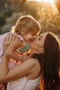 Beautiful Mother And Baby outdoors. Nature. Beauty Mum and her Child playing in Park together. Outdoor Portrait of happy Royalty Free Stock Photo