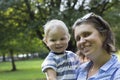 Beautiful Mother And Baby outdoors. Nature. Beauty Mum and her Child playing in Park together.