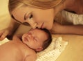 Beautiful mother with blond hair kissing her baby Royalty Free Stock Photo