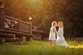 Beautiful mother blonde in white dress gently hugs a girl kneeli Royalty Free Stock Photo